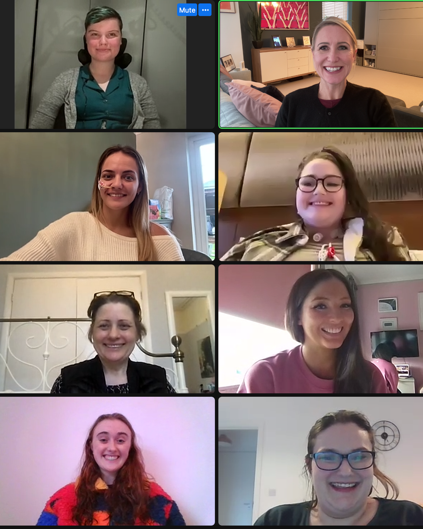 Screenshot of a video call showing eight women in various indoor settings, all smiling.
