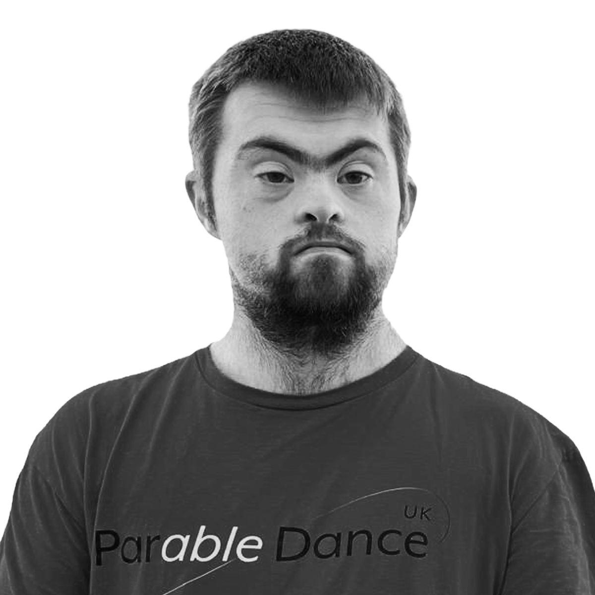 A man with short hair and a beard wearing a black T-shirt with the text 'Parable Dance UK' in black and white.