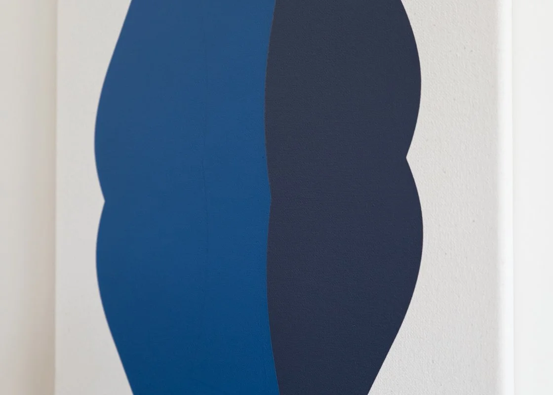 Abstract painting with blue and black curved shapes on a white wall.