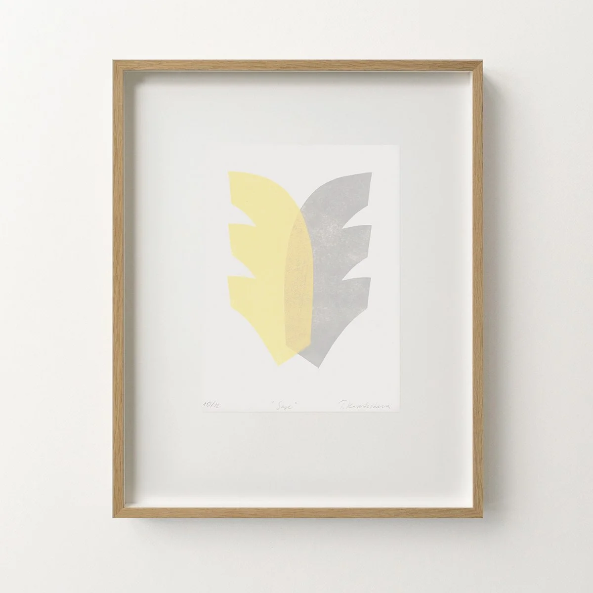 Framed abstract print with yellow and grey shades on a white wall. Variable Editions, unique art prints  by Switzerland based  artist Tetiana Kartasheva.