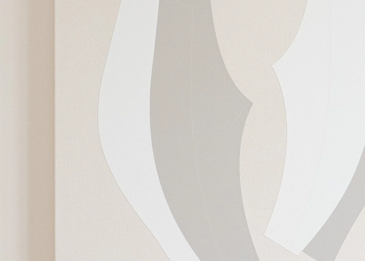 Close-up of a wall with abstract, wavy, overlapping shapes in shades of white and light gray.