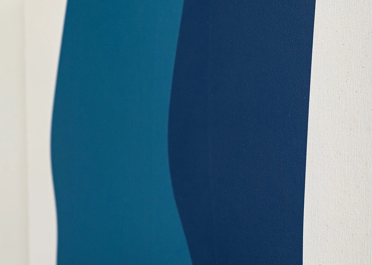 Close-up of a textured surface with curved shapes in shades of blue and teal on a white background.