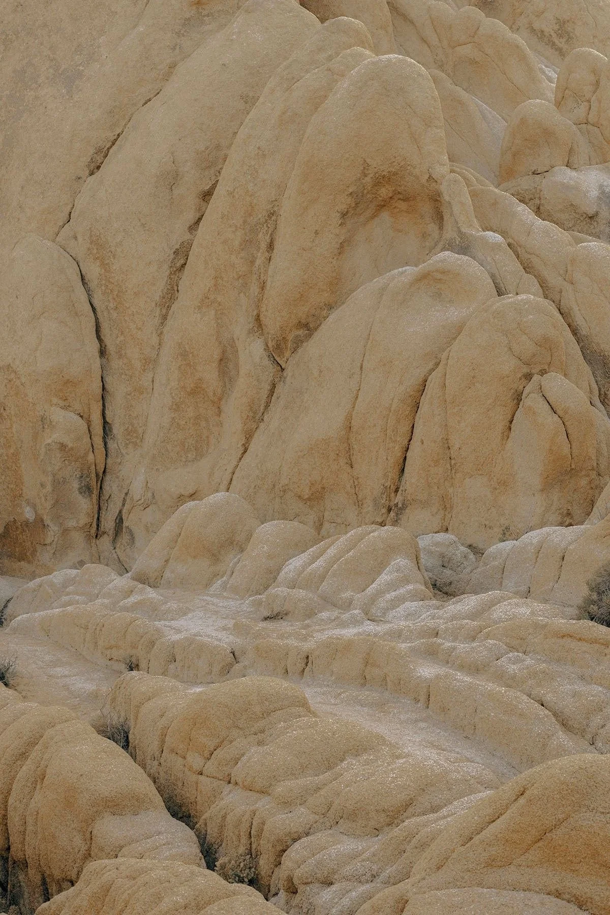 Close-up view of large beige and cream-colored rocks and boulders in a desert landscape.