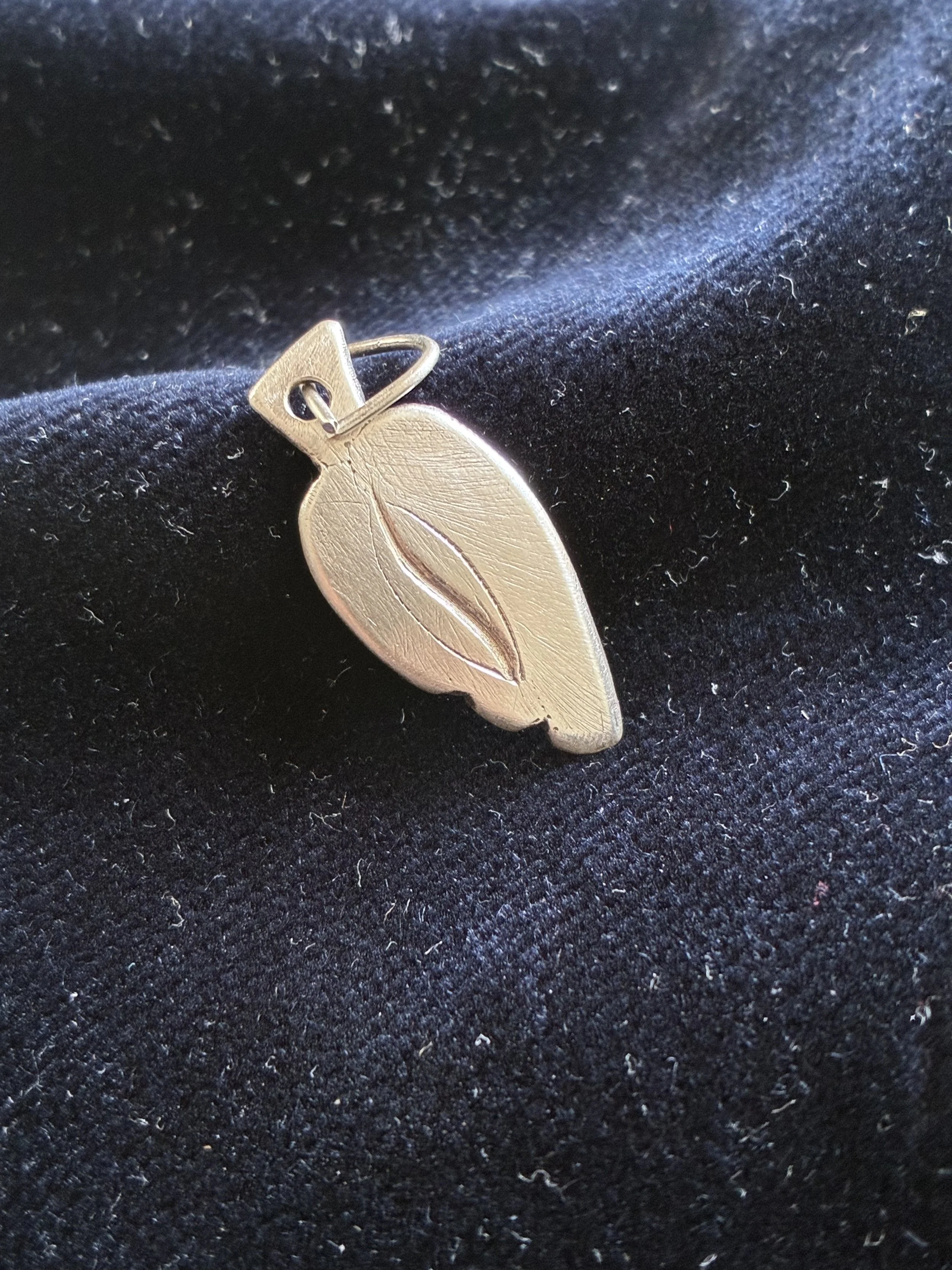pesteh, handmade silver pendant, abstract form of a pistachio which is a Persian symbol