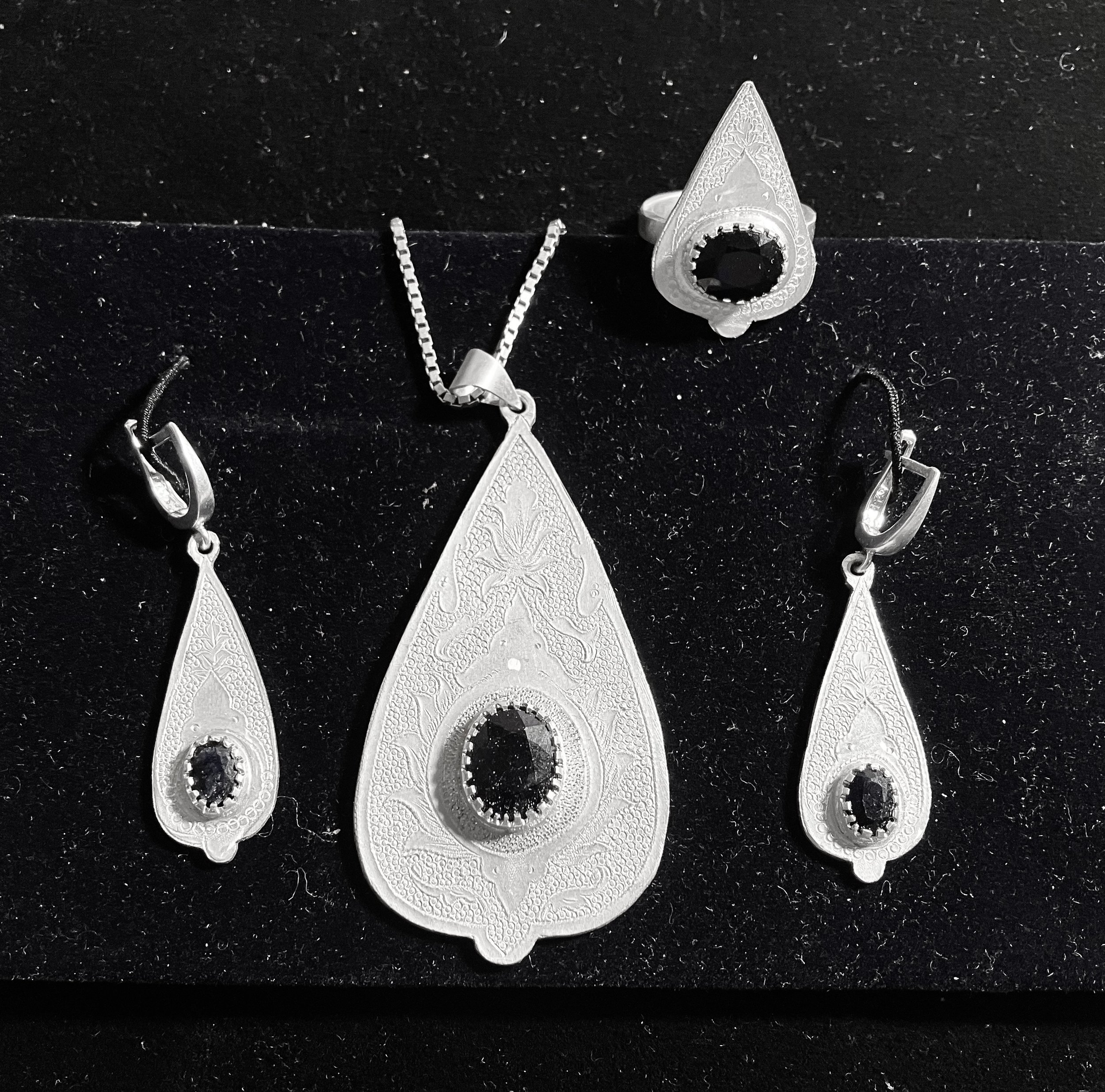Designed and handcrafted silver set with blue diamonds