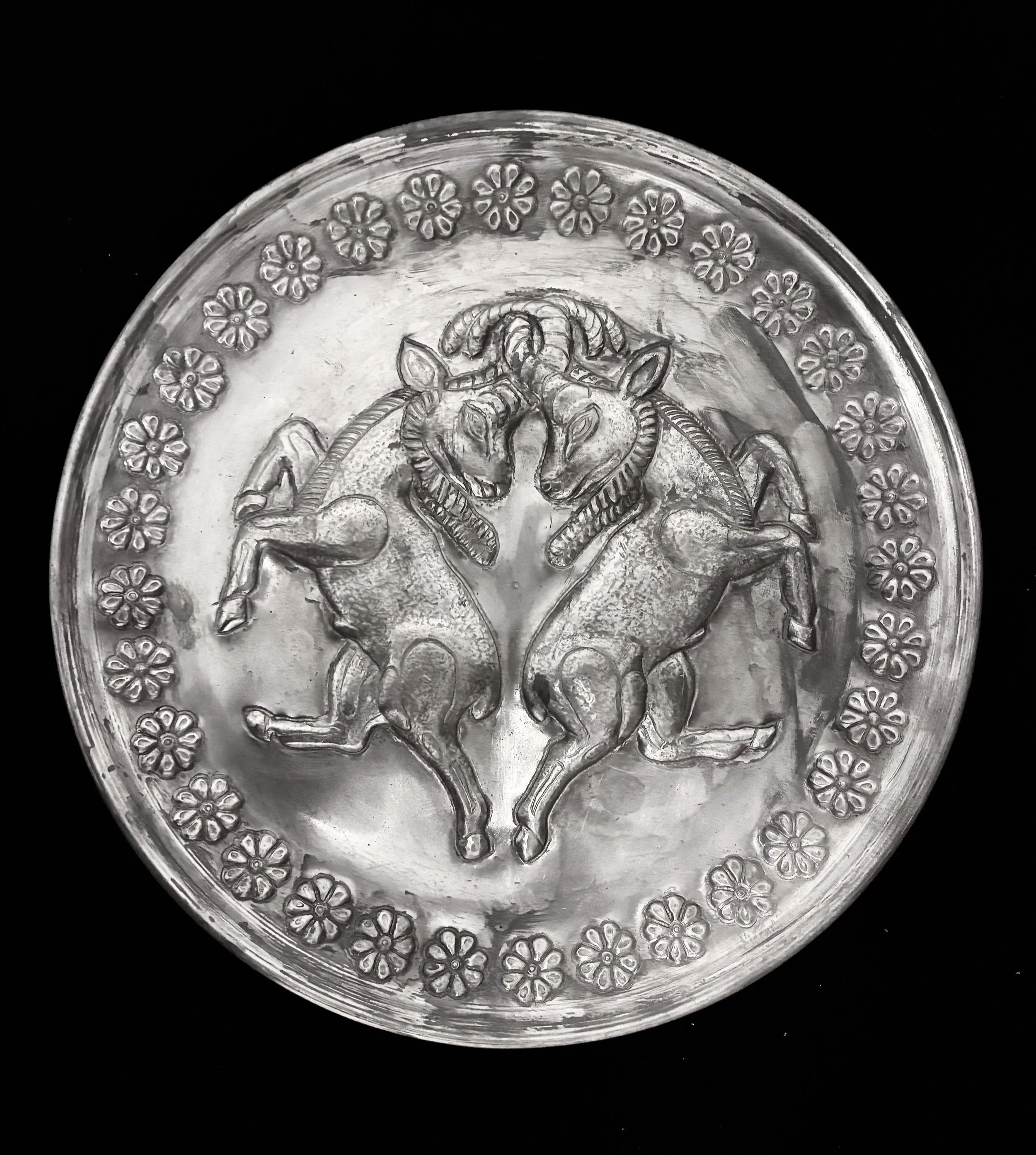 Goat as legendary symbols, hand sculpted on a metal sheet