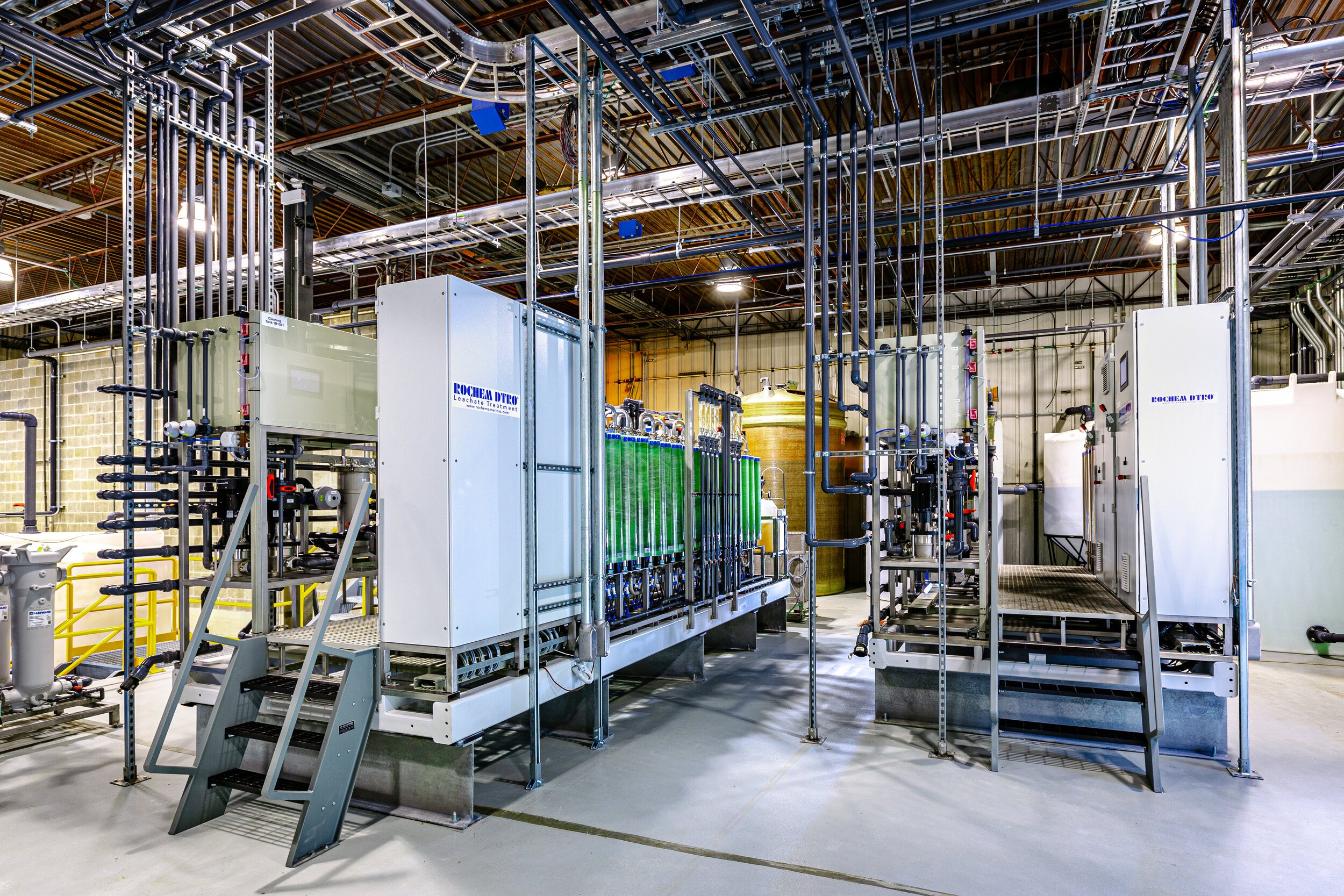 Industrial water treatment system with piping and machinery in a facility.