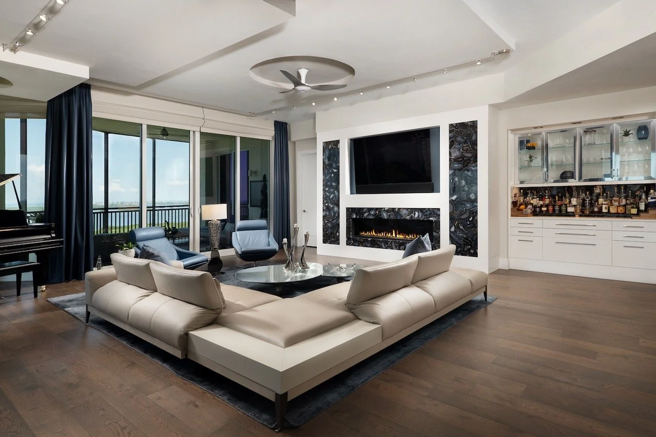 modern-penthouse-living-room-sectional-fireplace-built-in-bar-gloria-black-design.jpeg