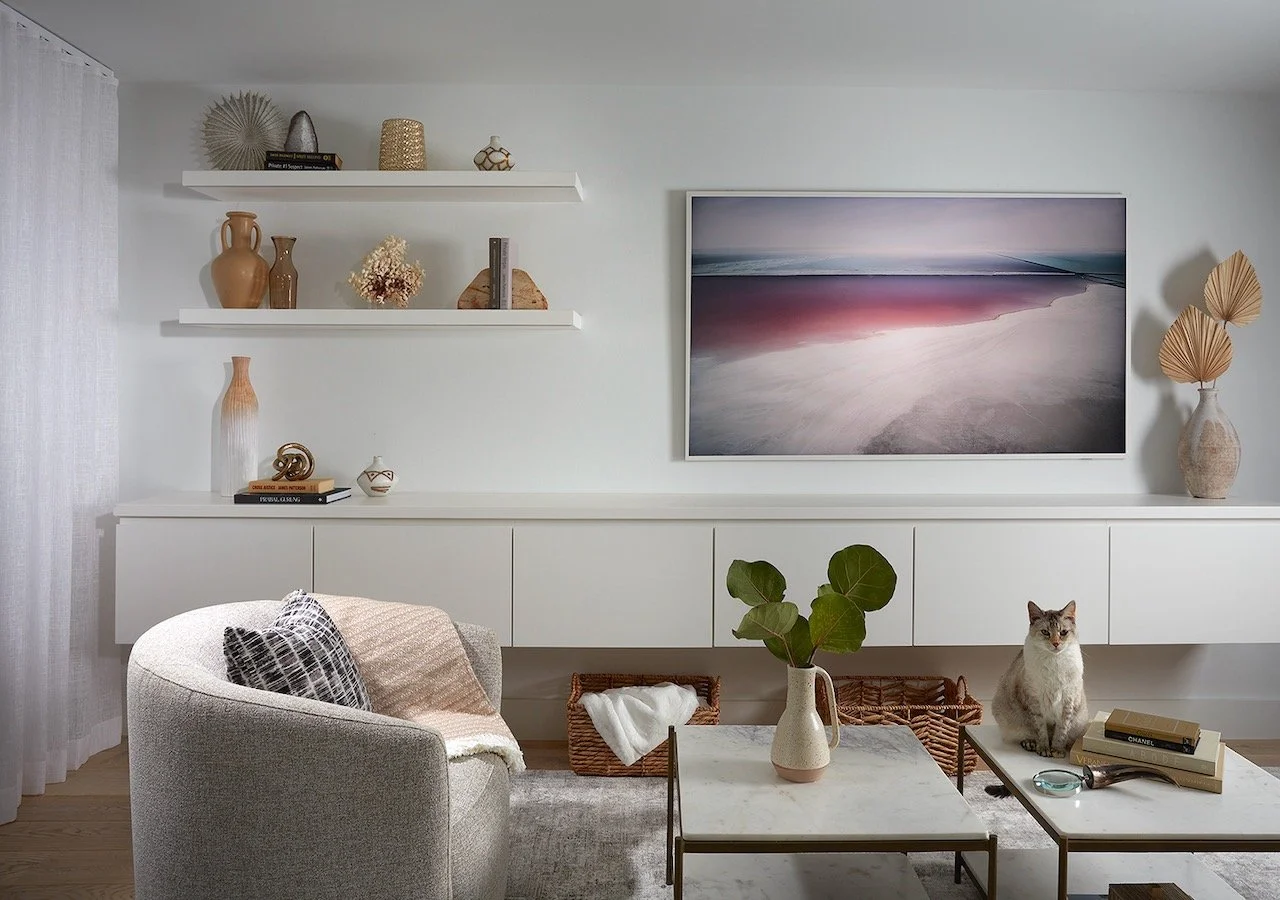 Gulfshore Getaway beachfront condo living room shelving with coastal artwork and curated accessories — Gloria Black Design Naples Florida