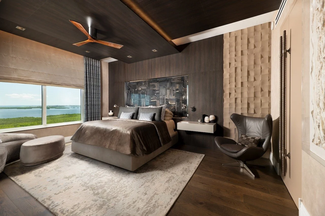 modern-penthouse-primary-bedroom-upholstered-headboard-textured-walls-gulf-views-gloria-black-design.jpeg