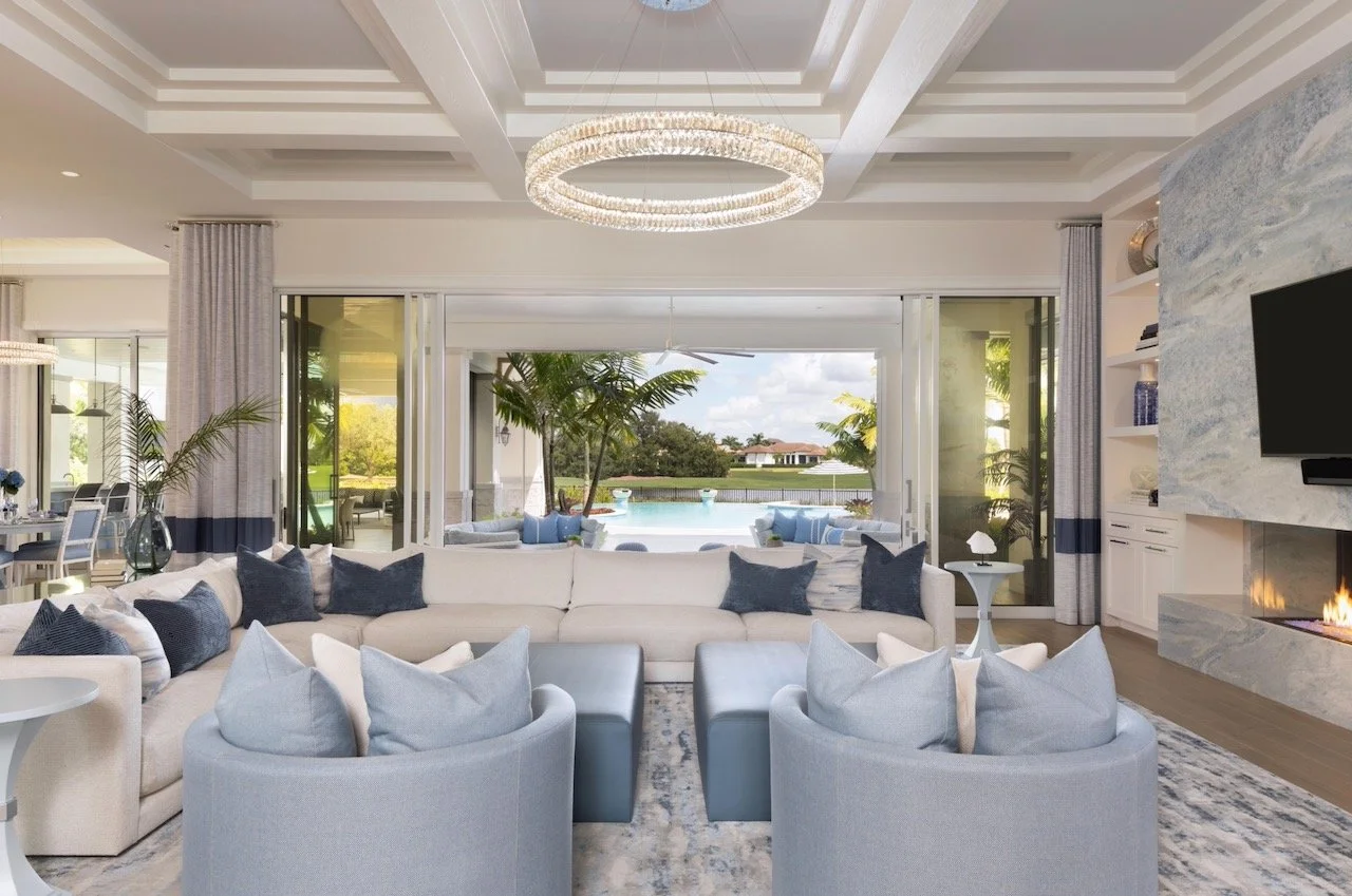 new-england-charmer-living-room-blue-sectional-chandelier-pool-views-gloria-black-design-©51.jpeg