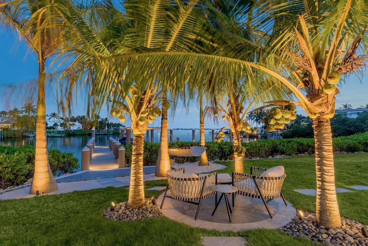 Writer's Repose custom waterfront dock with illuminated palm trees at dusk, Stuart Florida — Gloria Black Design