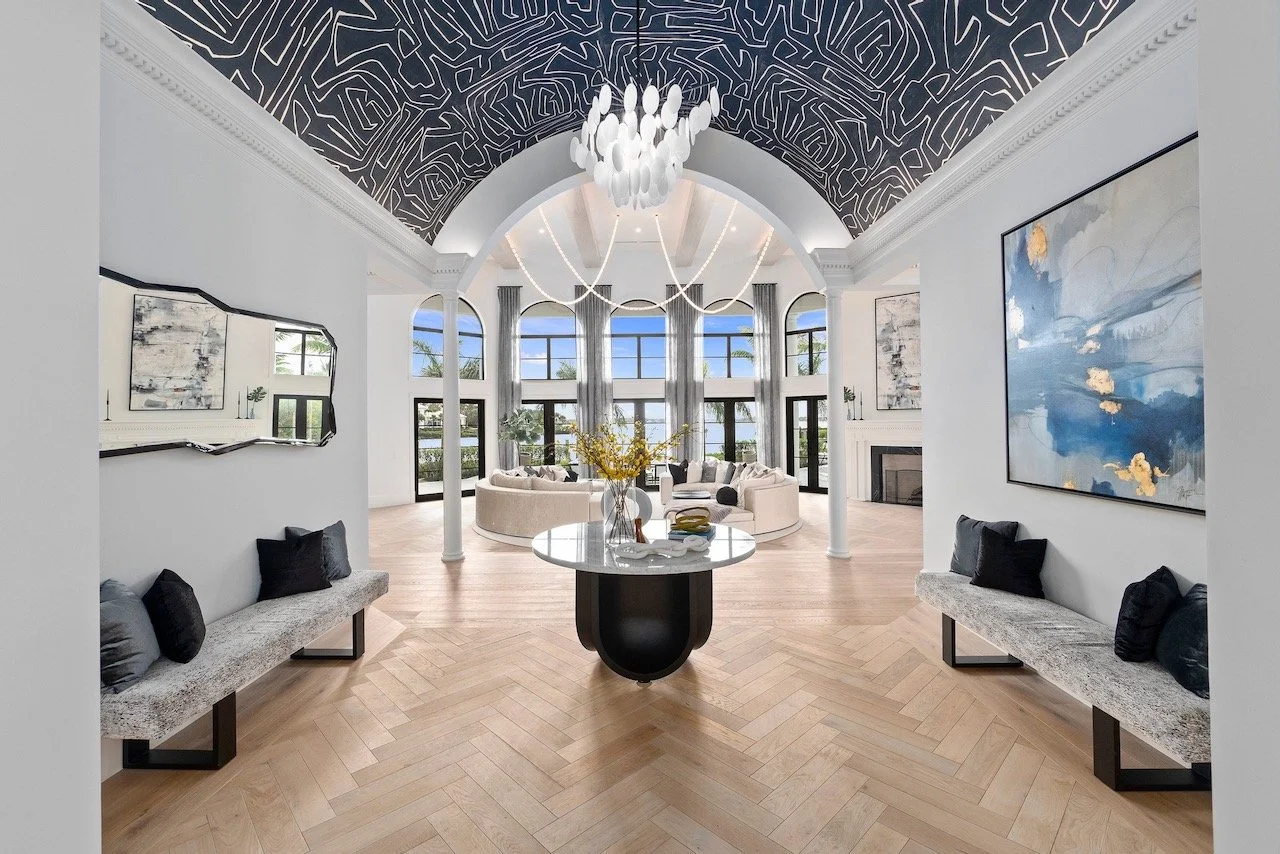 Writers Repose grand foyer with arched ceiling, topographic wallcovering, sculptural chandelier and herringbone floors — Gloria Black Design