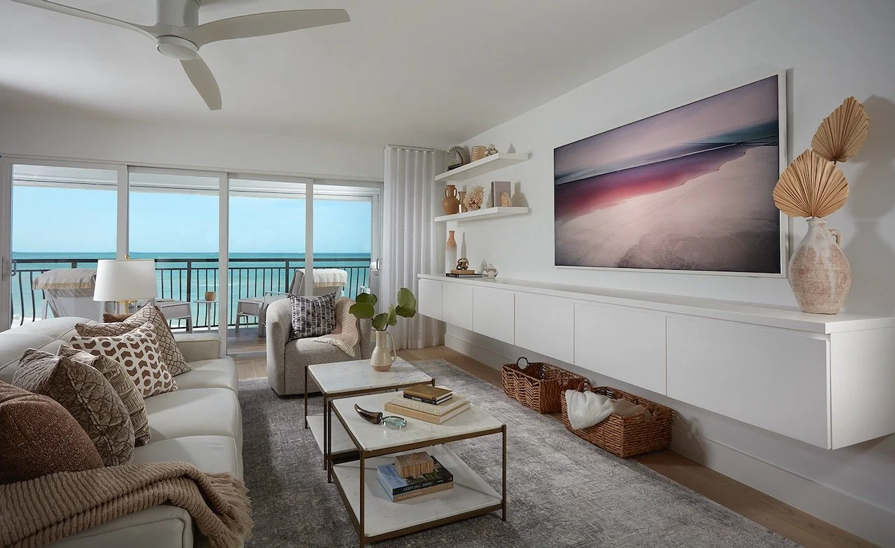 Gulfshore Getaway by Gloria Black Design — bright coastal luxury living room with panoramic Gulf of Mexico views, neutral linen palette, custom built-ins, and organic textures, Naples Florida beachfront interior design