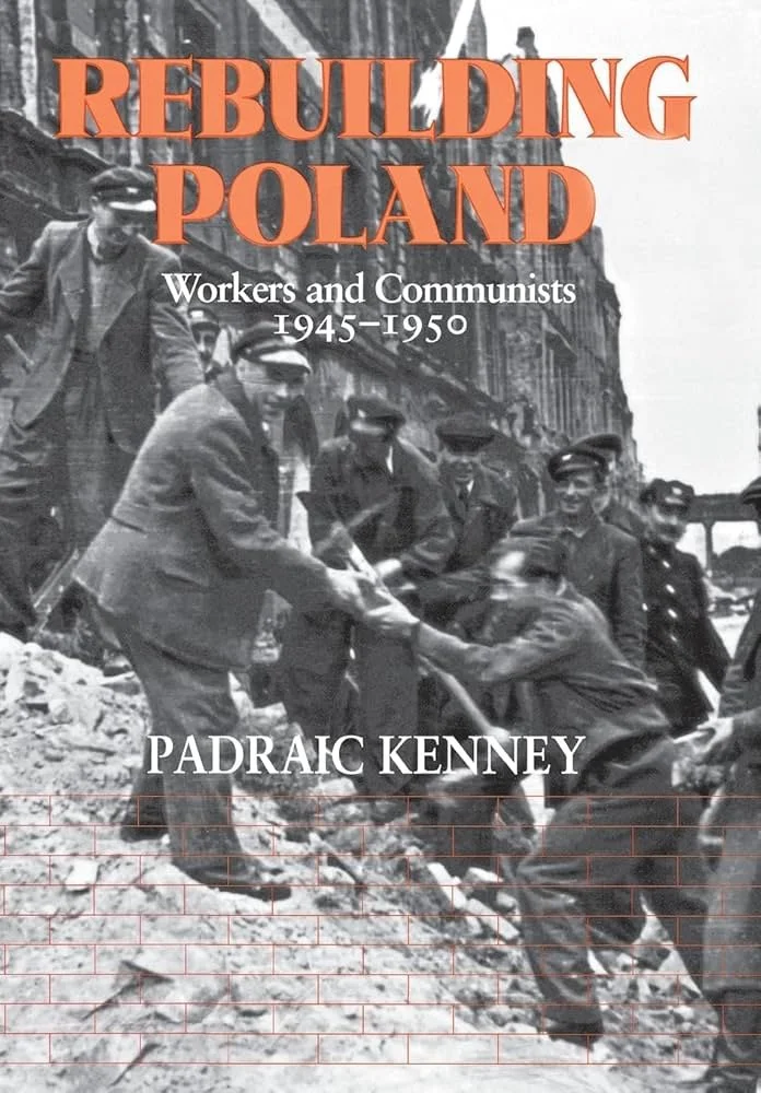 Book cover titled "Rebuilding Poland: Workers and Communists 1945-1950" by Padraic Kenney features a black-and-white photograph of workers and communists during the reconstruction period in Poland, with some shaking hands amid a rubble-strewn street.