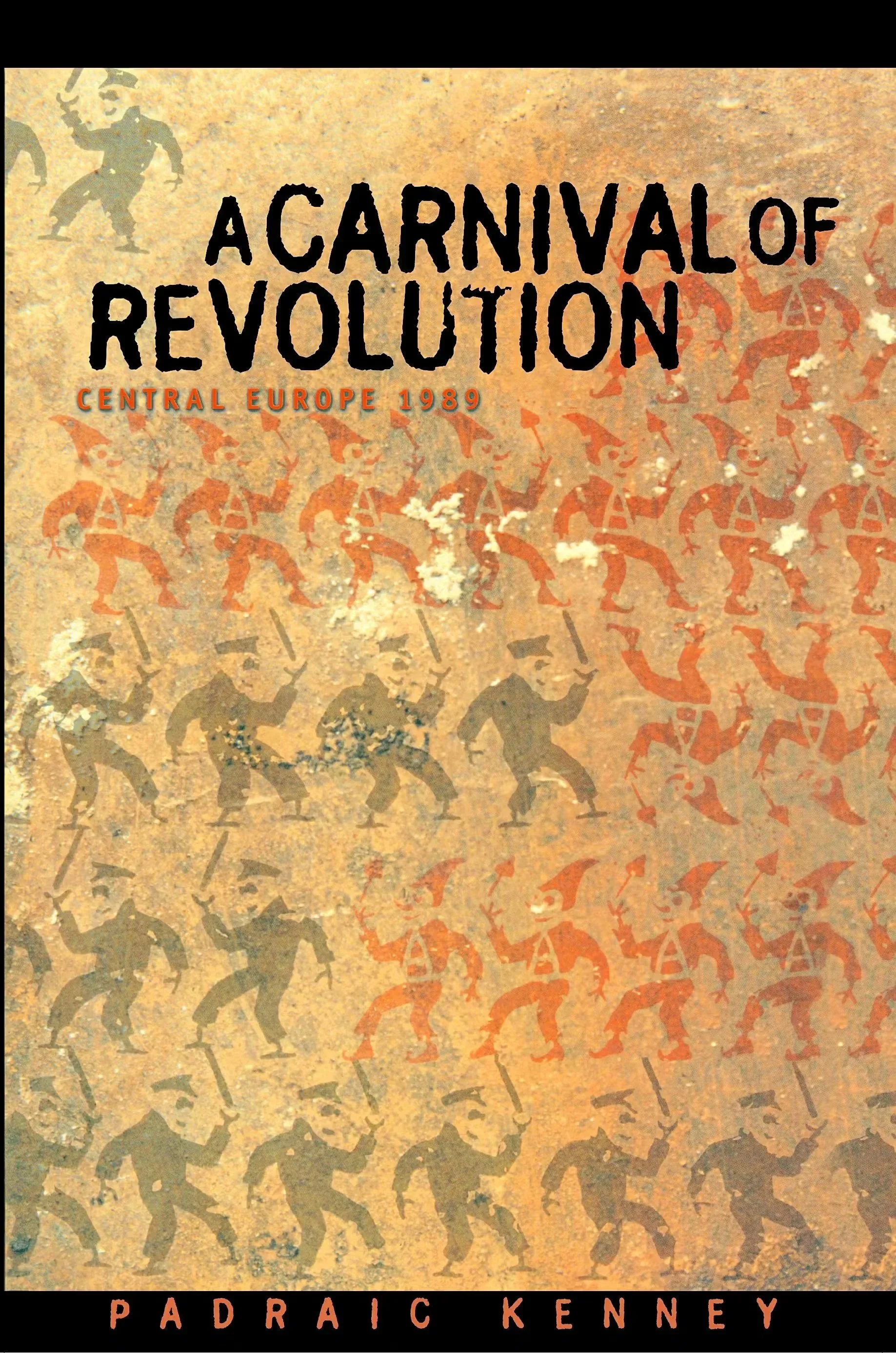 Book cover titled 'A Carnival of Revolution: Central Europe 1989' by Padraic Kenney. The background features stylized silhouettes of protestors or revolutionaries, arranged in a dance-like pattern in shades of orange, black, and beige.
