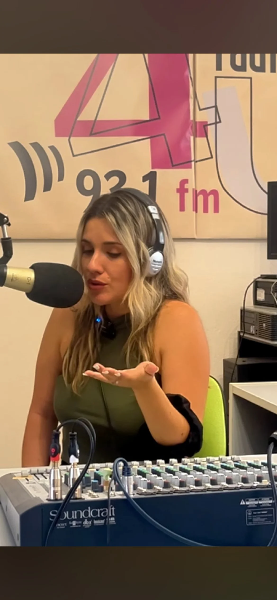 Evi Georgiou speaking in a radio studio during a live broadcast