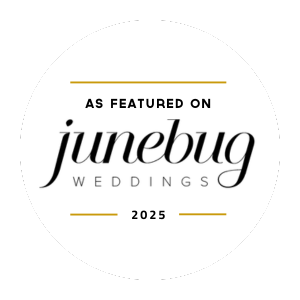 A circular logo with a black background and white center, featuring the text 'As featured on junebug weddings 2025'.