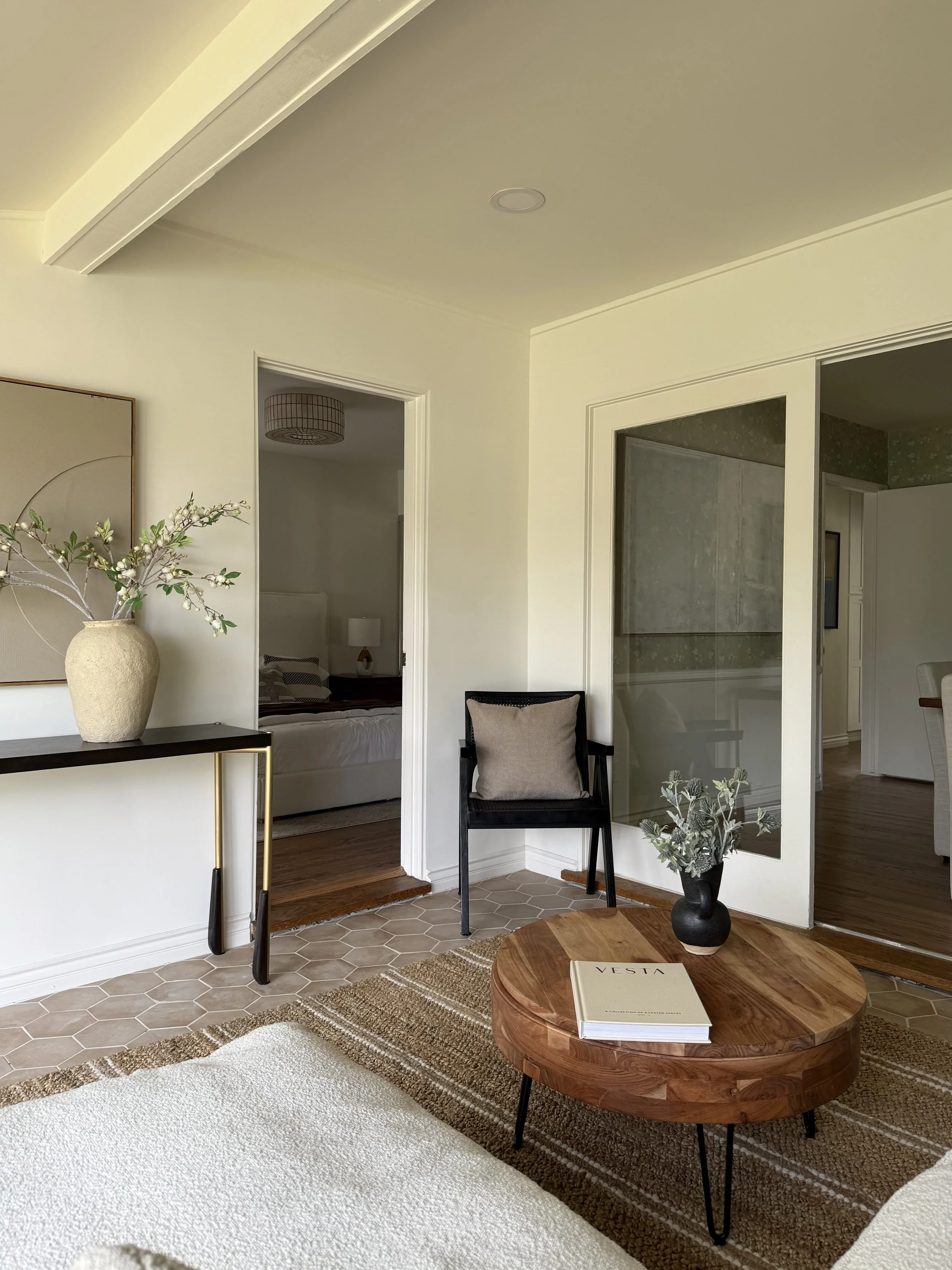 Den of home with wood coffee table, vase and large mirror