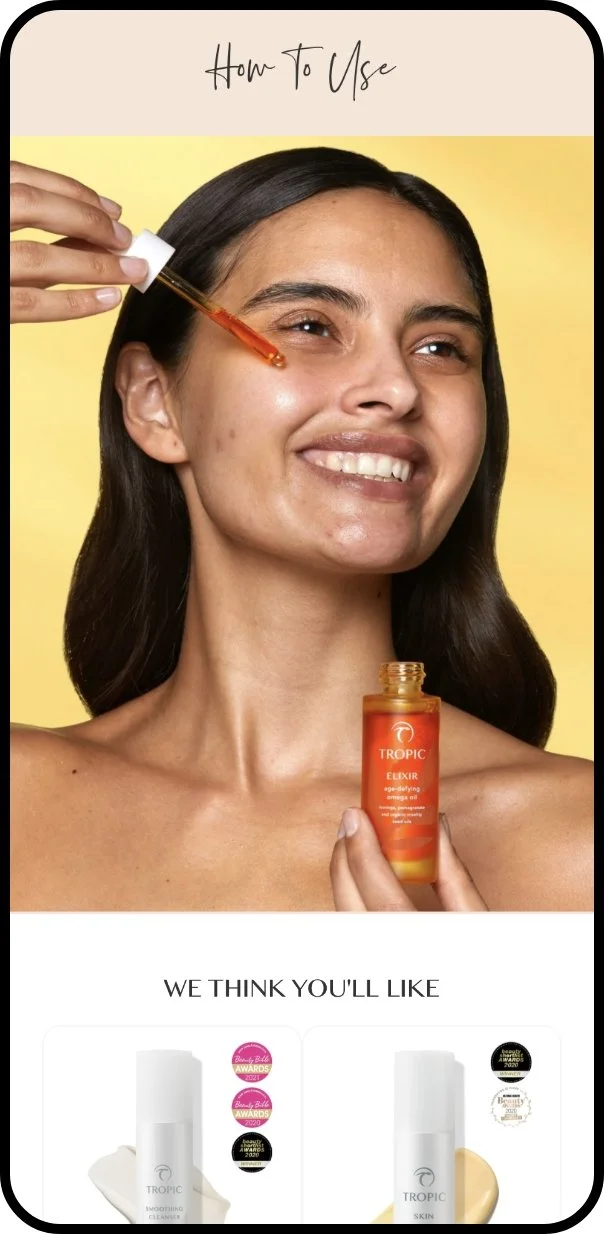Woman smiling while applying a facial serum with a dropper, holding a bottle labeled Tropic Elixir, with skincare product images below.