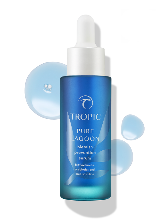 Blue bottle of Tropic Pure Lagoon blemish prevention serum with drops of serum surrounding it.