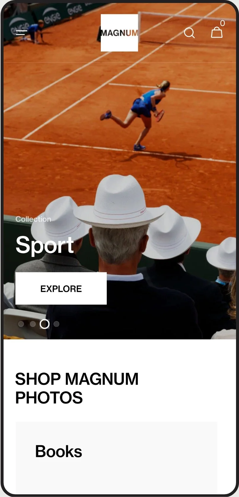 A tennis player running on a clay court during a match, with spectators in white hats watching from the stands.