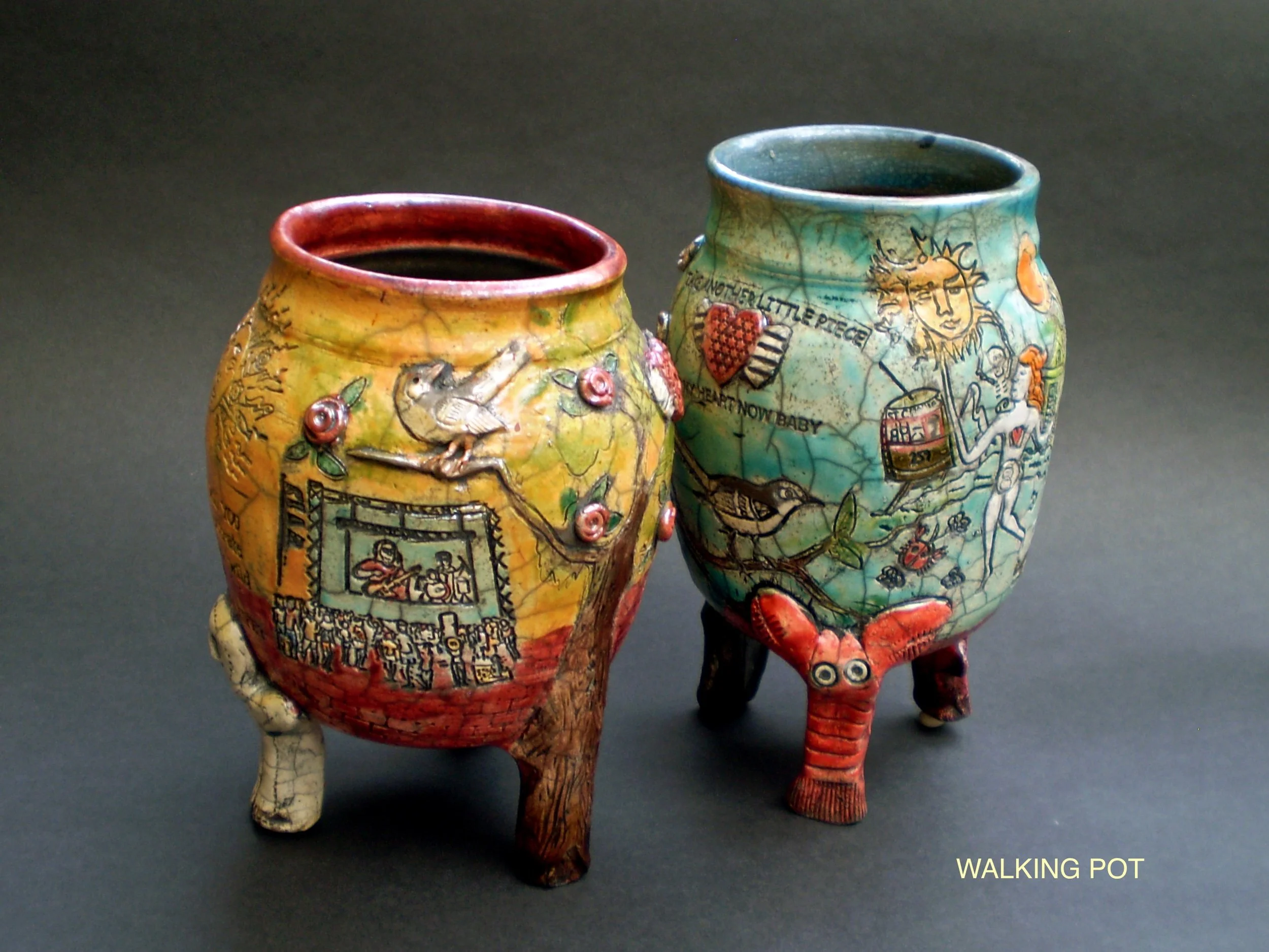 two raku fired colorful jars with unusual legs