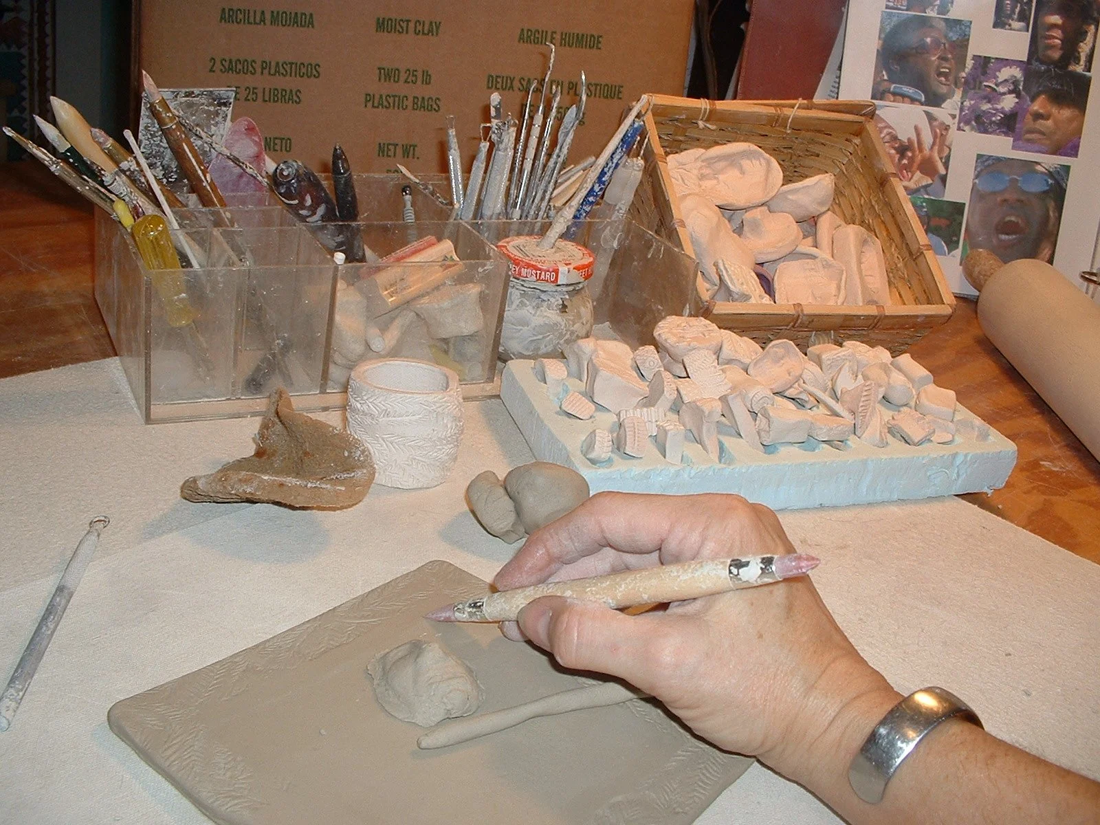 artist working on a wall plaque