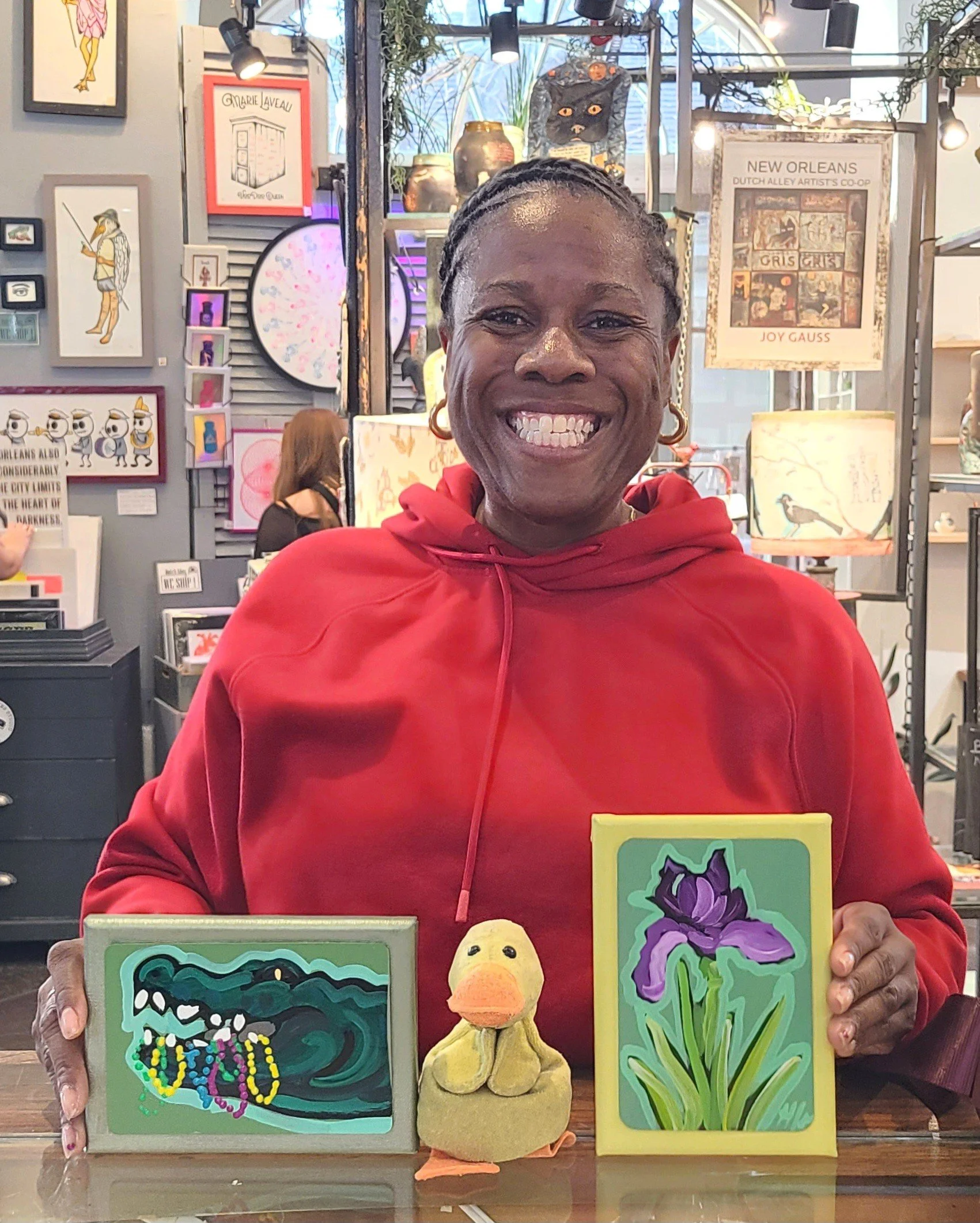 Smiling woman with  two note cards and a duck on the counter in front of her