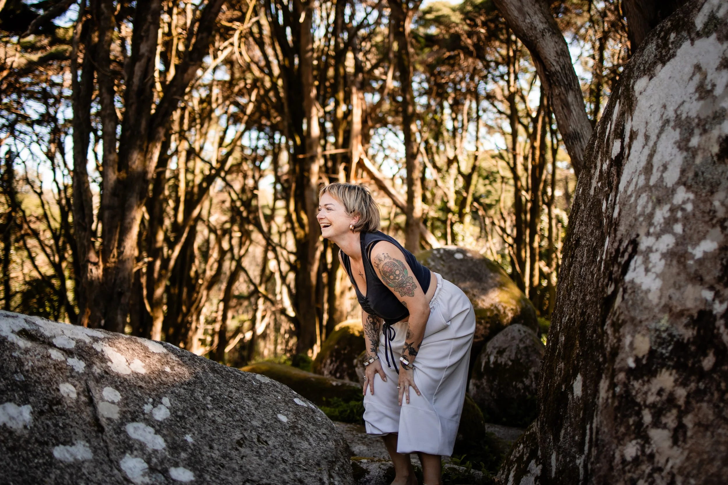 womanlaughingnexttorockintheforest