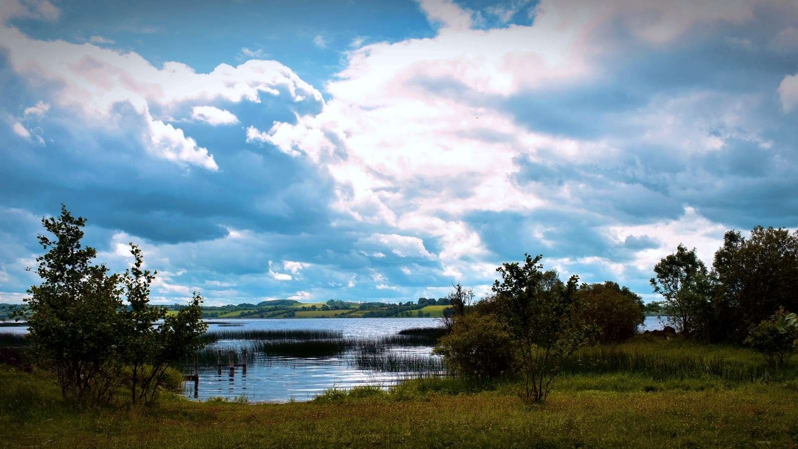 A peaceful scene at Swan lake county Meath, surrounded by open countryside, showcasing the natural landscapes explored on private tours through Ireland.
