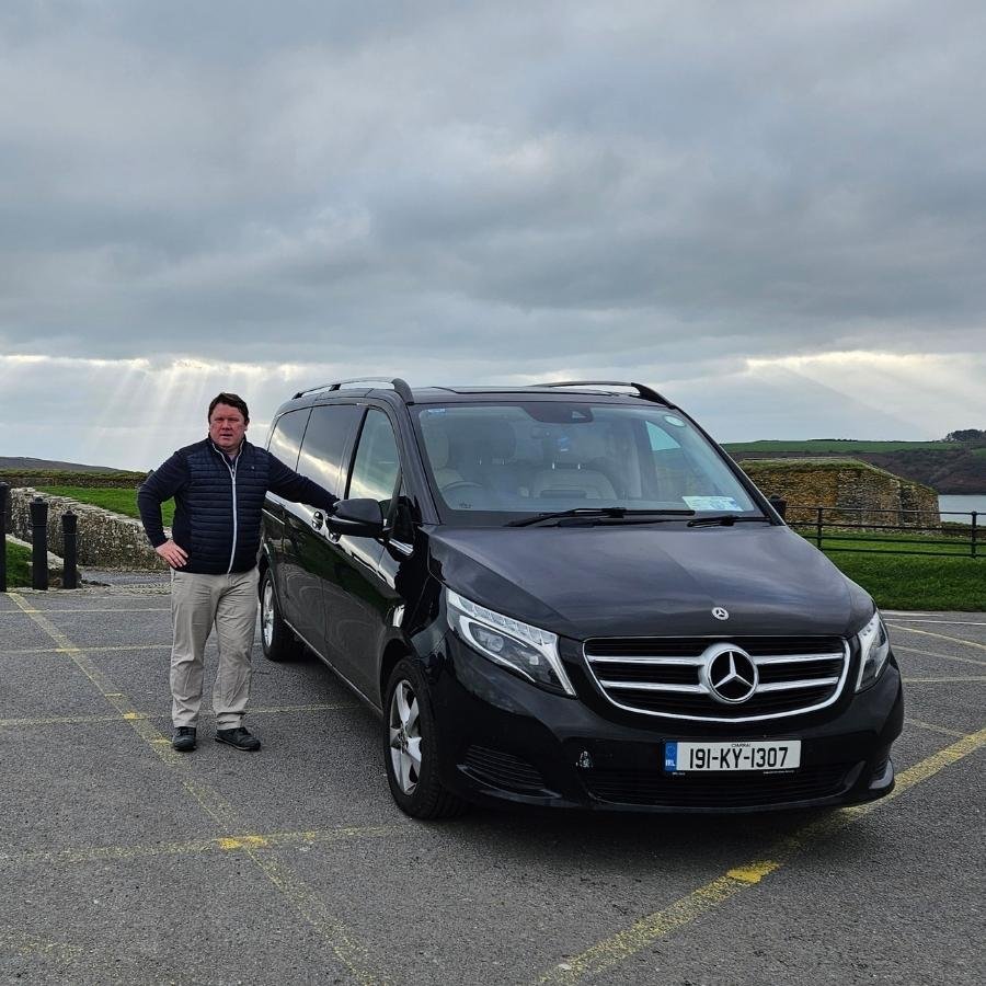 Private driver guide beside a Mercedes V Class during a scenic tour with Private Tours Ireland