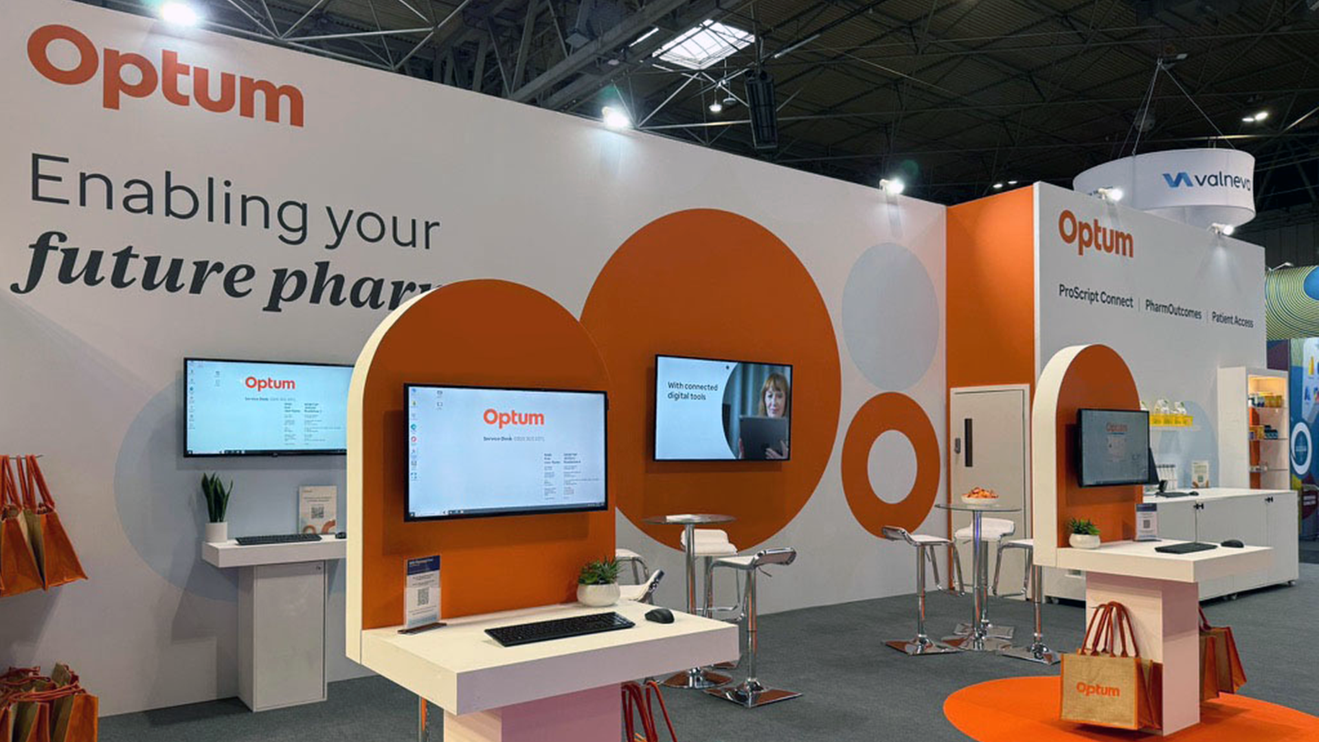 Image showing close up of the front stand elevation, a large backdrop with Optum branding and messaging with two podium stands in the forefront