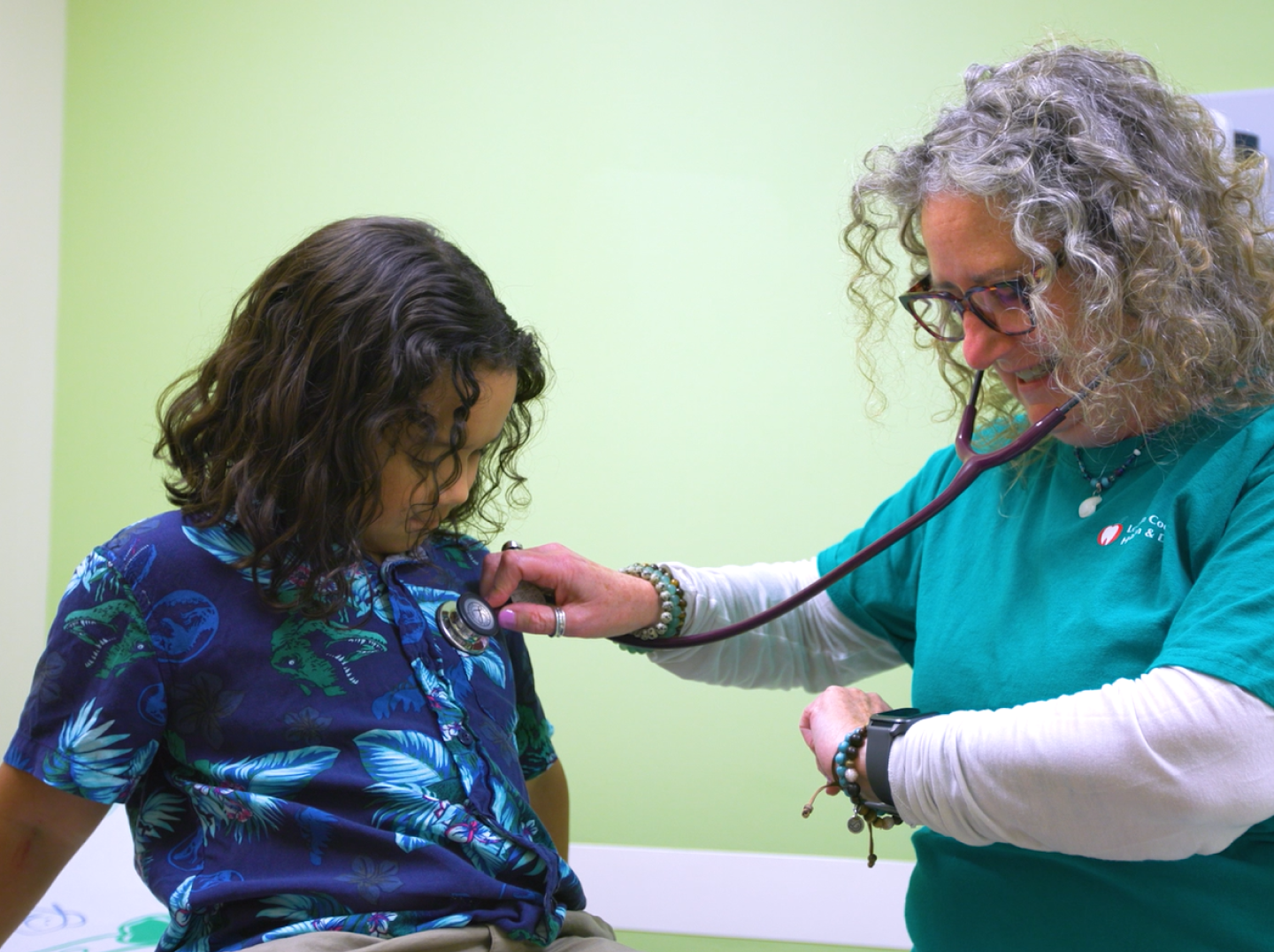 Child patient getting his pulse checked by a nurse