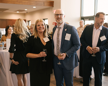 people enjoyig drinks and smiling for the camera