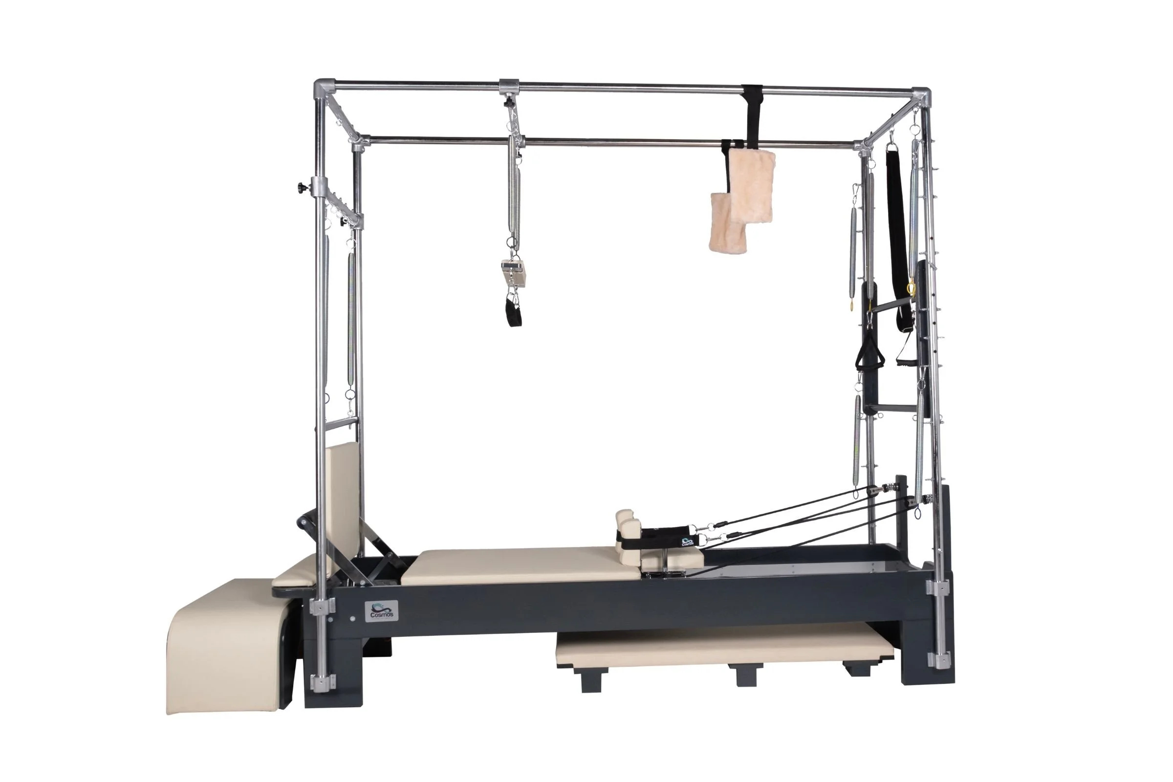 A Pilates reformer machine with various straps and accessories, including a padded foot bar and a metal frame.