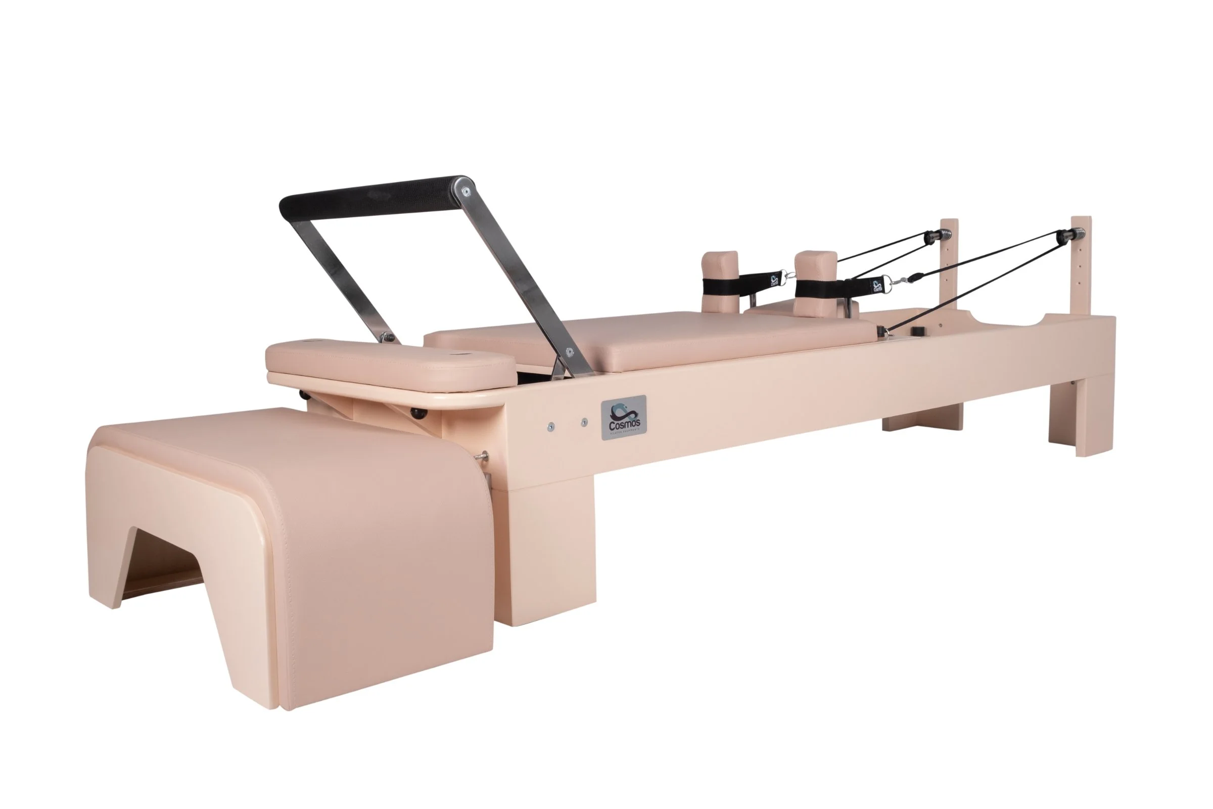 Pilates reformer machine with padded platform, metal bars, and resistance cords for exercise and physical therapy.