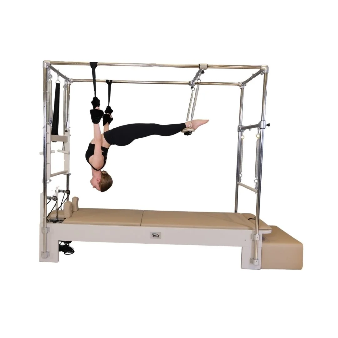 Cadillac Reformer Pilates equipment with trapeze and attachments for full-body workouts