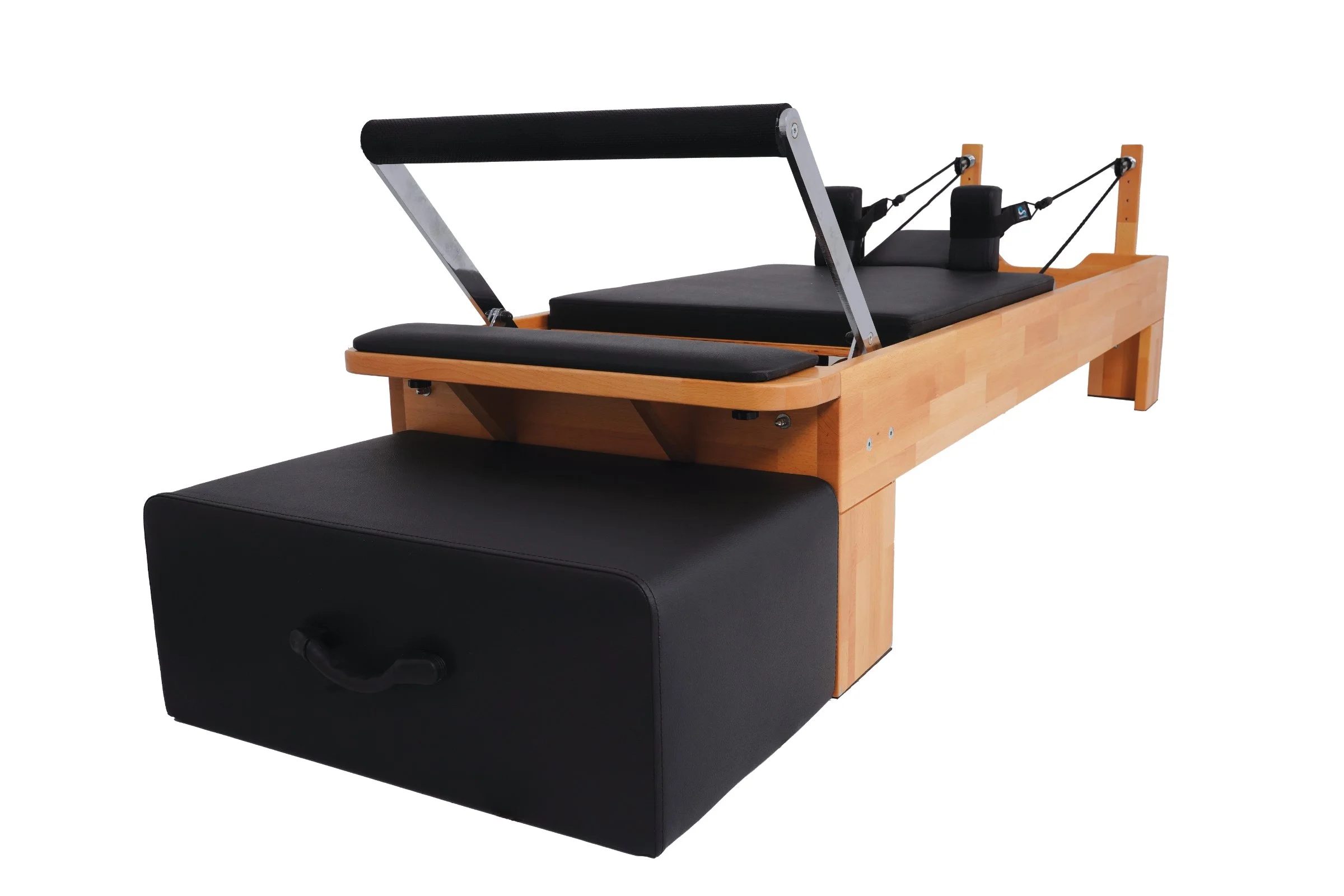 Pilates reformer machine with a wooden frame, black cushioned platform, and adjustable straps.