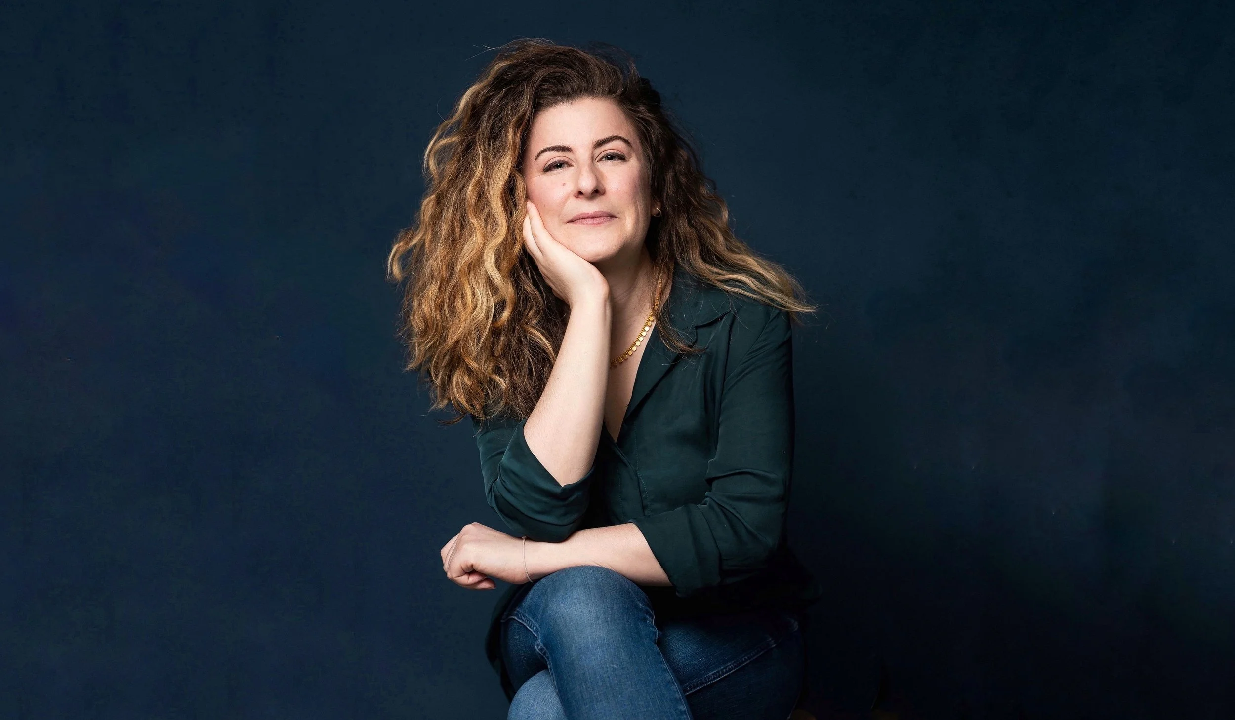 A portrait of Emily sitting down