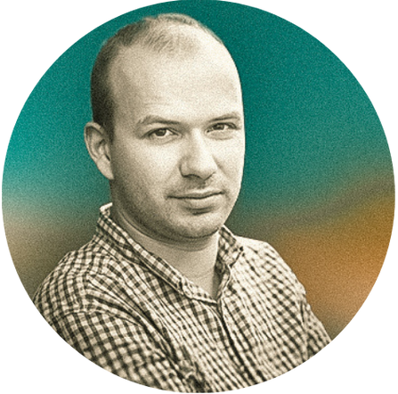 A portrait of a man with short hair, wearing a checkered shirt, against a gradient background.