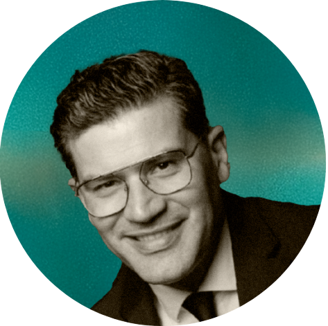 Black and white photograph of a man wearing glasses, Marijan Srsen, a suit, and tie, smiling, with a greenish background