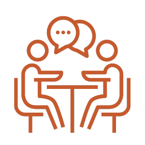 Two people sitting at a table having a conversation, represented by speech bubbles above them.