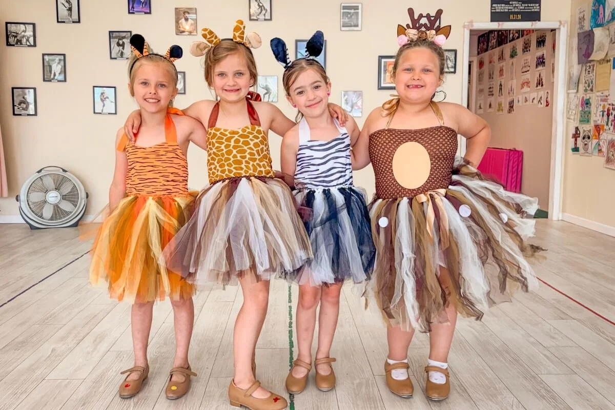 Tap cancers posing in a dance studio, dressed in dance costumes