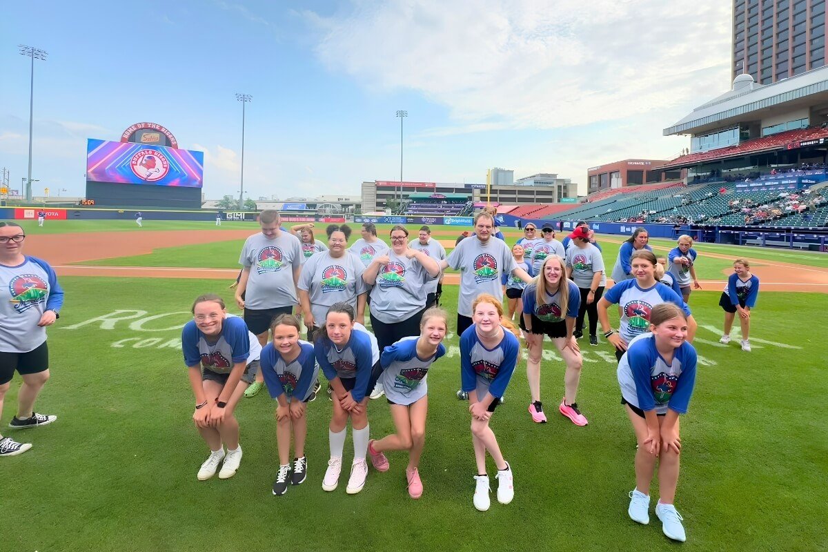 Group of Young and adult dancers on the Buffalo Bisons Baseball field performing