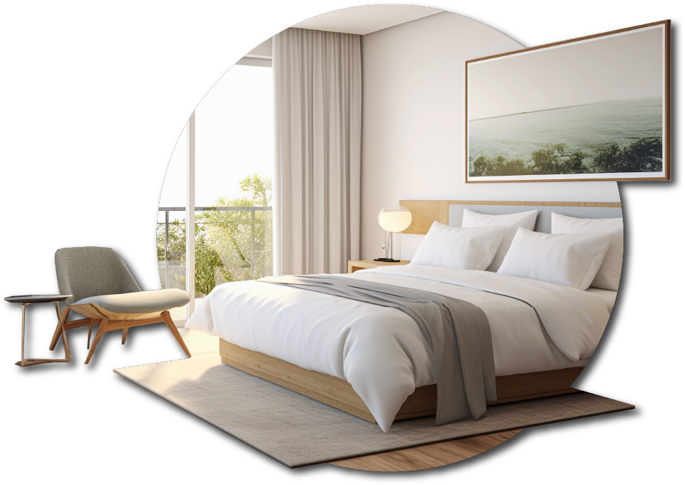 Modern boutique hotel guest room with a large bed, white bedding, gray blanket, wooden headboard, and a landscape painting above. A bedside lamp on a small wooden nightstand, a gray armchair with wooden legs.