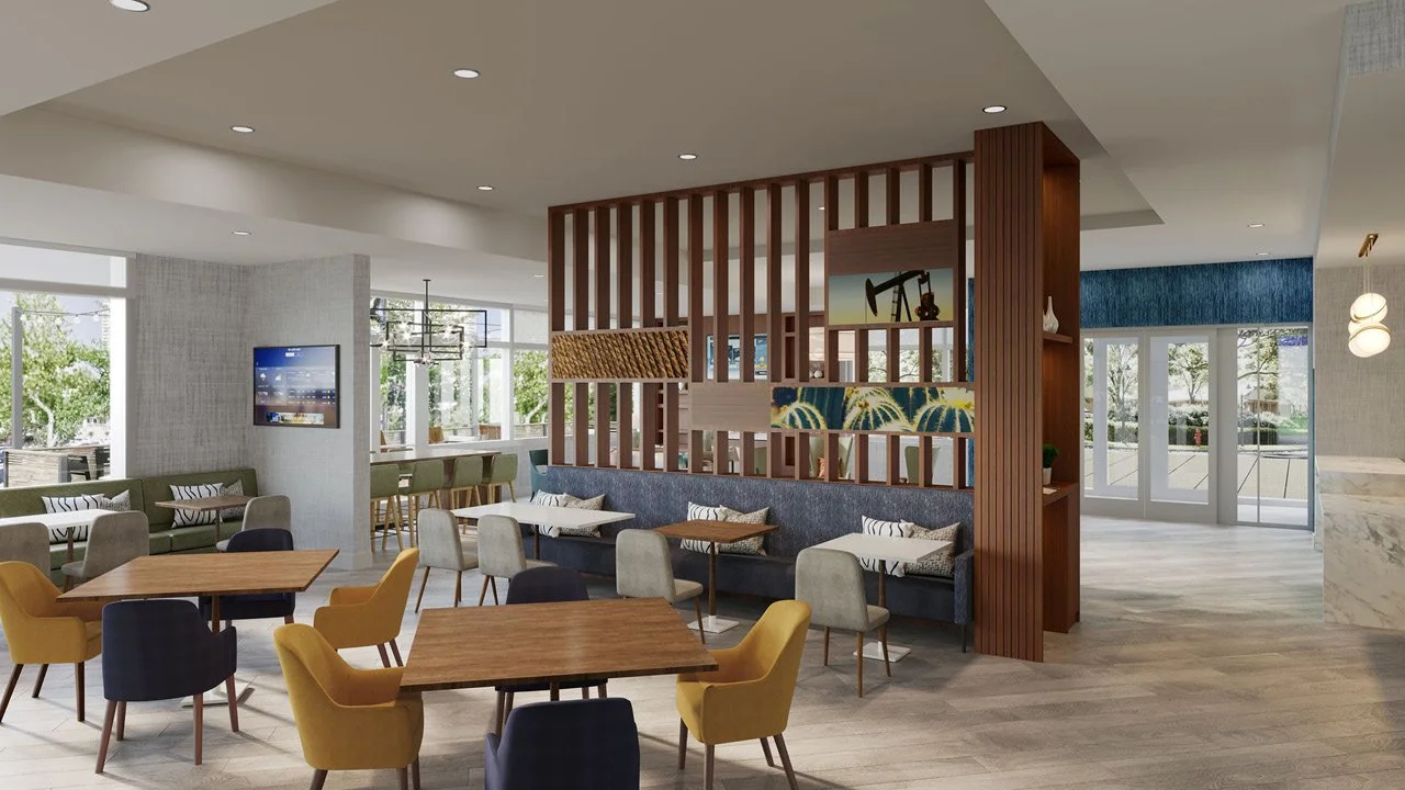 A modern Comfort by Choice Hotels Rise & Shine lobby lounge area with wooden tables, colorful upholstered chairs, and a decorative wooden partition with various art pieces. Large windows let in natural light, and there is a bar in the background.