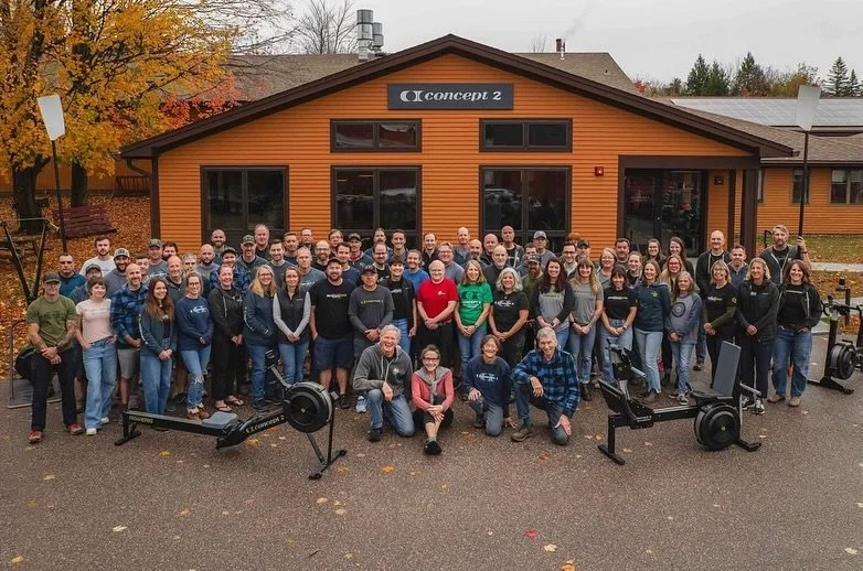 a photo of the concept2 founders and employees in front of their headquarters