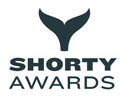 Logo of Shorty Awards featuring a whale tail symbol and the text 'Shorty Awards'.