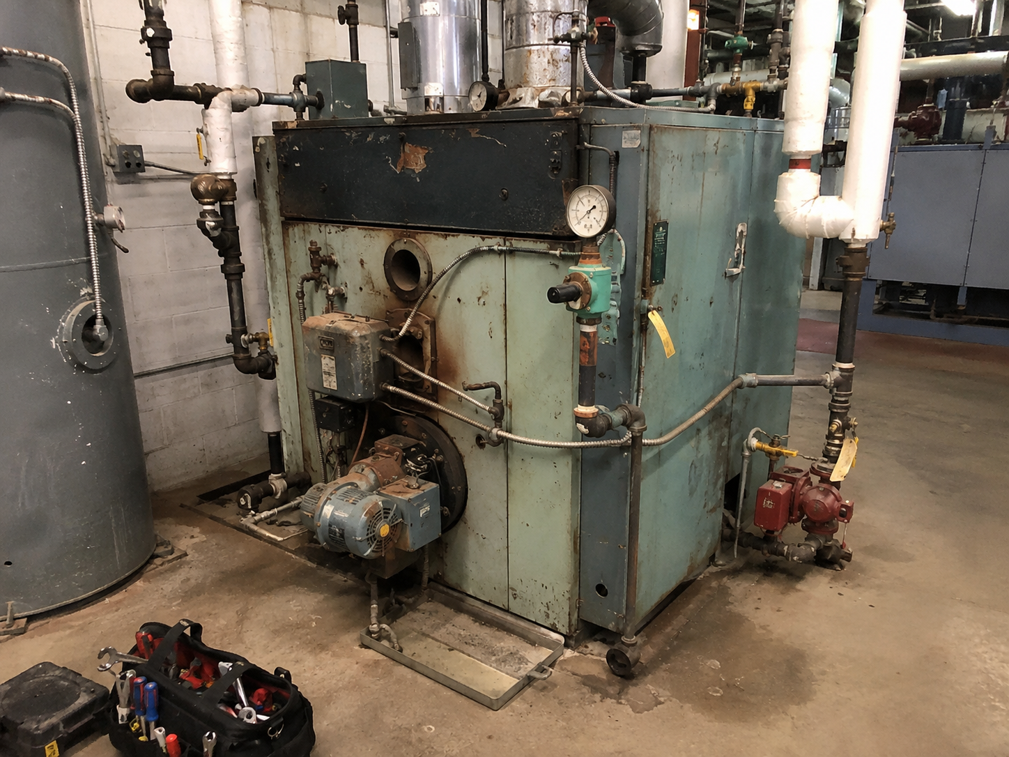 Boiler and mechanical room that is still operating but clearly nearing replacement